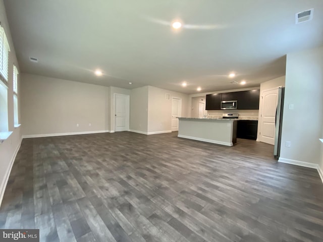 unfurnished living room featuring recessed lighting, visible vents, baseboards, and dark wood-style floors