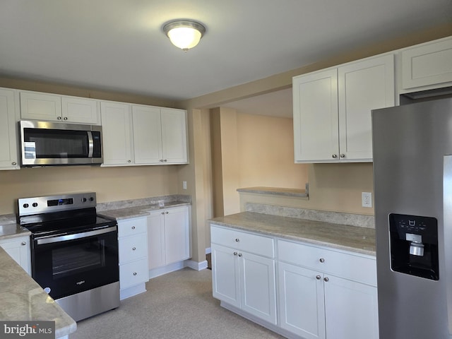 kitchen featuring white cabinetry, light countertops, and stainless steel appliances