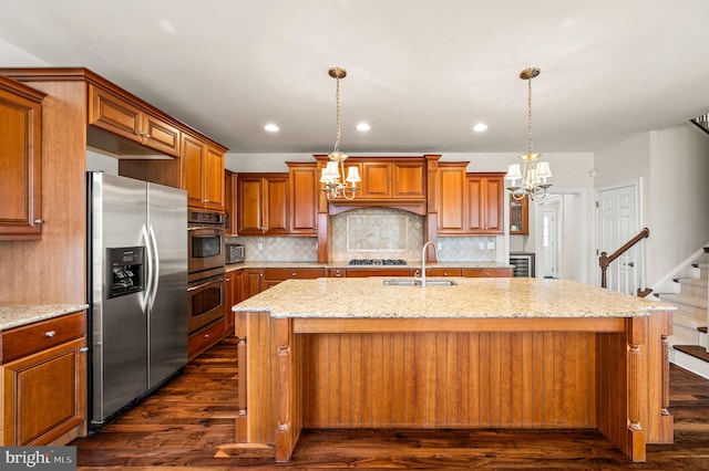 kitchen featuring a notable chandelier, dark wood-style flooring, stainless steel appliances, and a sink