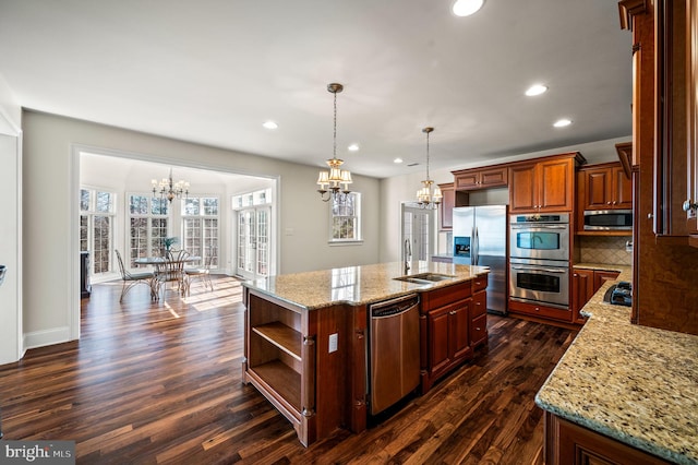 kitchen with tasteful backsplash, open shelves, appliances with stainless steel finishes, an inviting chandelier, and a sink