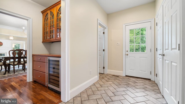 interior space featuring brick floor, baseboards, plenty of natural light, and beverage cooler