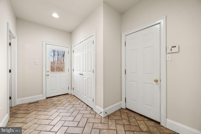 interior space with brick floor and baseboards