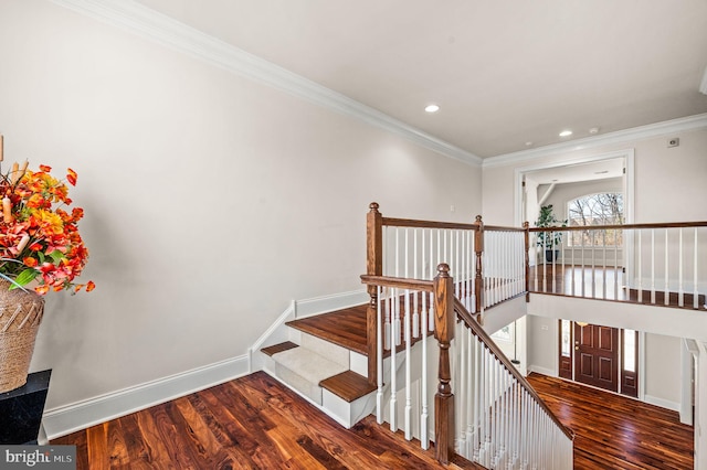 stairway with recessed lighting, crown molding, baseboards, and wood finished floors