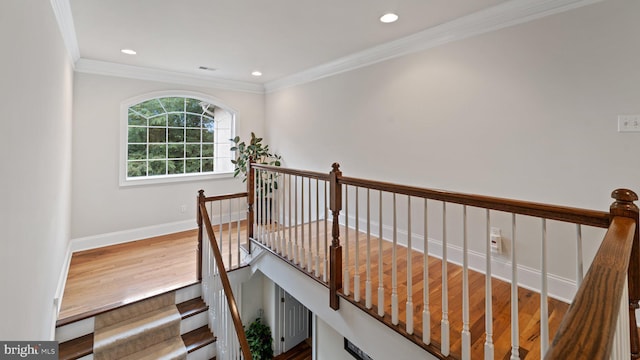 stairway featuring visible vents, crown molding, baseboards, recessed lighting, and wood finished floors