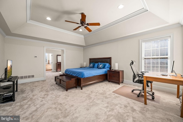 bedroom with visible vents, baseboards, carpet, a tray ceiling, and ornamental molding