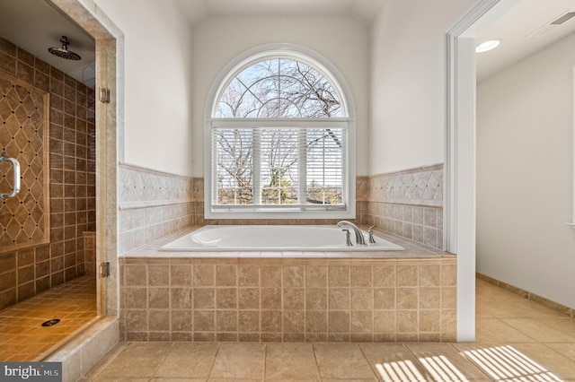 bathroom featuring visible vents, lofted ceiling, a shower stall, tile patterned floors, and a bath