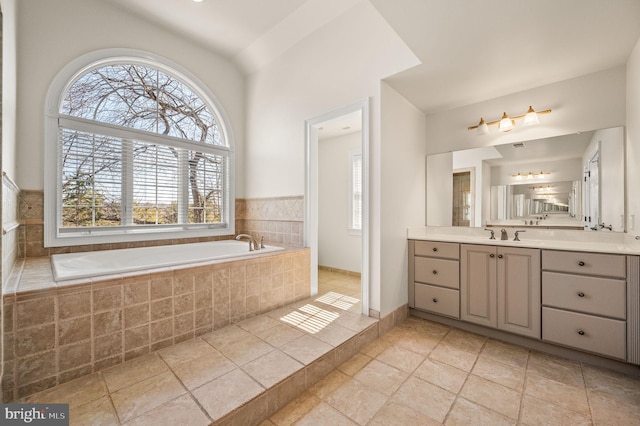 bathroom featuring a garden tub and vanity