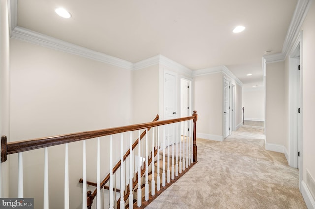 hallway with recessed lighting, an upstairs landing, light colored carpet, and ornamental molding