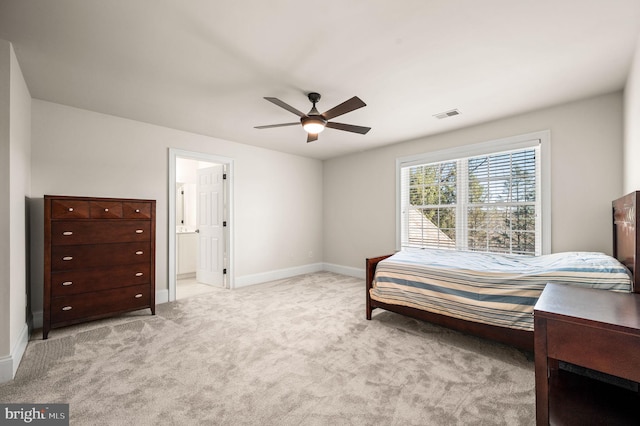 bedroom featuring visible vents, ensuite bathroom, carpet, baseboards, and ceiling fan