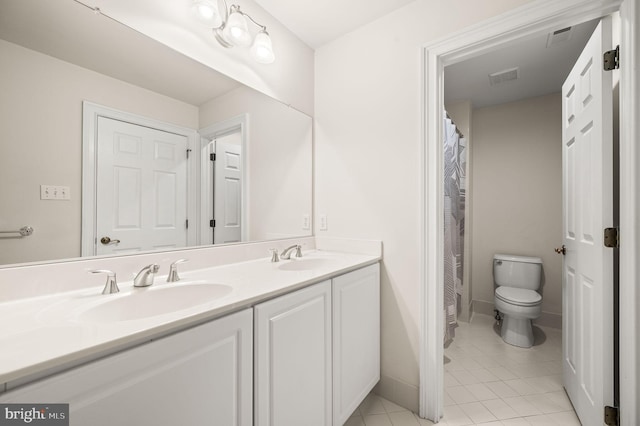 full bath featuring tile patterned flooring, double vanity, toilet, and a sink