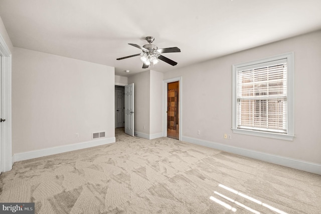 unfurnished bedroom featuring a ceiling fan, carpet flooring, baseboards, and visible vents