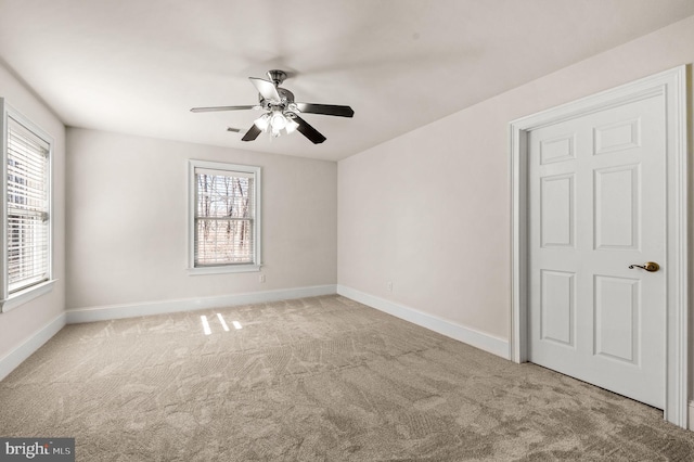 spare room featuring baseboards, carpet, and ceiling fan