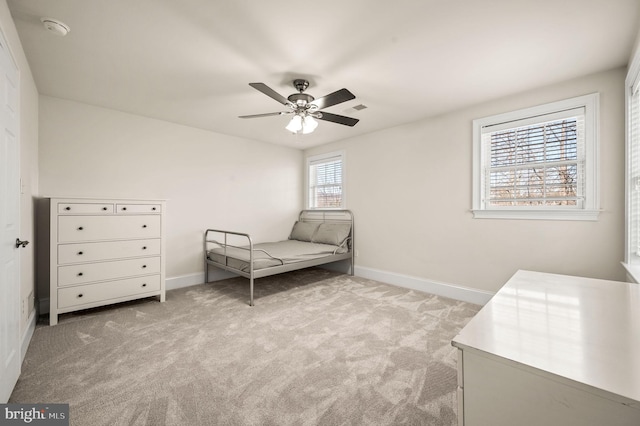 carpeted bedroom featuring visible vents, ceiling fan, and baseboards