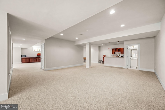 finished basement with recessed lighting, baseboards, and light colored carpet