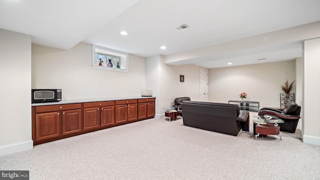 carpeted living area featuring visible vents, recessed lighting, and baseboards