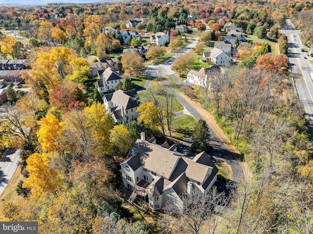 birds eye view of property featuring a residential view and a view of trees