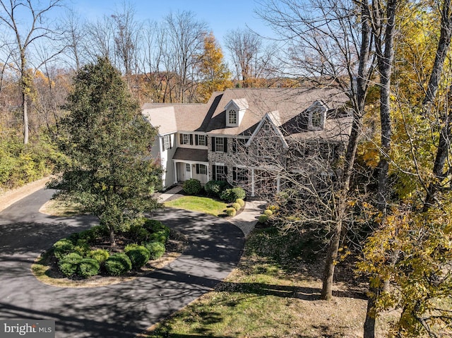 shingle-style home with driveway