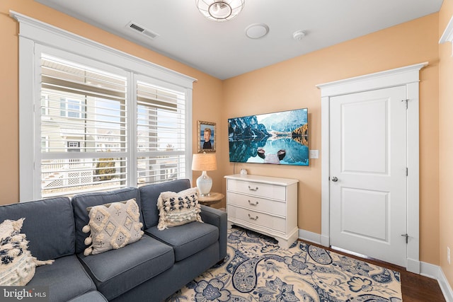 living room with plenty of natural light, baseboards, and visible vents