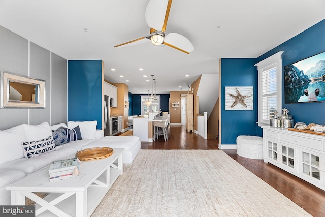 living room featuring baseboards, recessed lighting, dark wood-style flooring, and ceiling fan