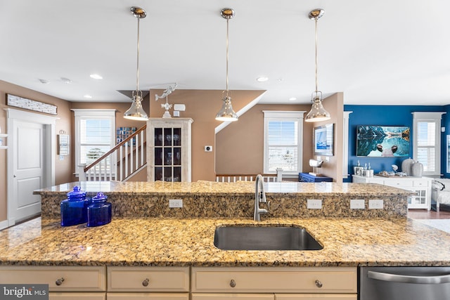 kitchen with dishwasher, open floor plan, a wealth of natural light, and a sink