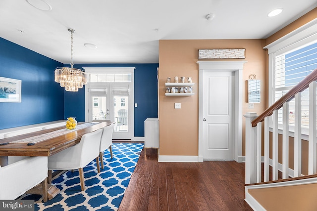 dining space featuring recessed lighting, a chandelier, baseboards, and wood finished floors