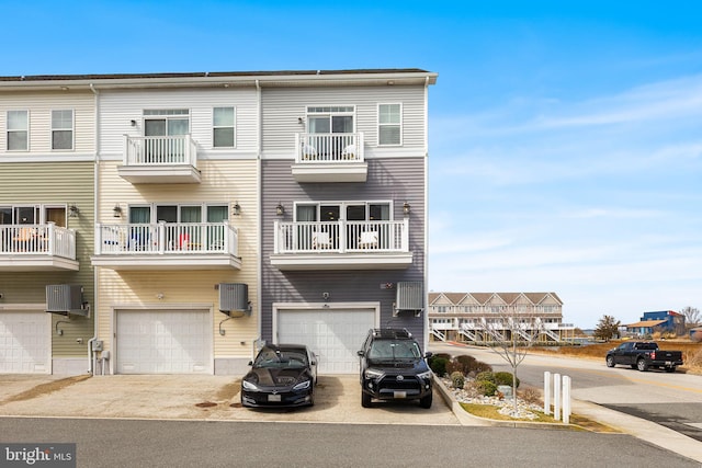 exterior space featuring cooling unit, driveway, and a garage