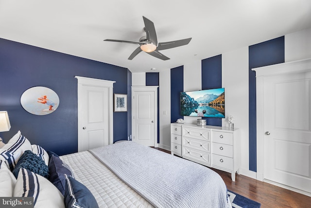 bedroom featuring a ceiling fan, wood finished floors, and baseboards