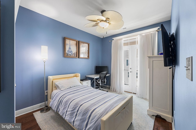 bedroom featuring wood finished floors, visible vents, baseboards, ceiling fan, and access to outside