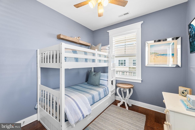 bedroom with visible vents, baseboards, wood finished floors, and a ceiling fan