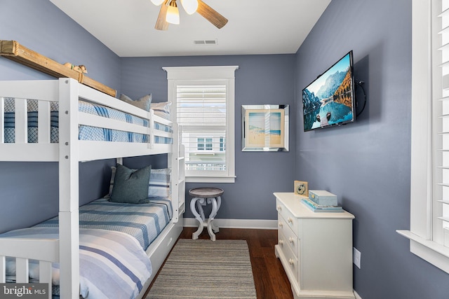 bedroom with dark wood finished floors, visible vents, ceiling fan, and baseboards