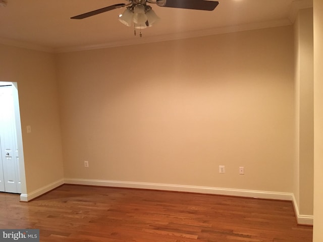 unfurnished room featuring ceiling fan, wood finished floors, baseboards, and ornamental molding