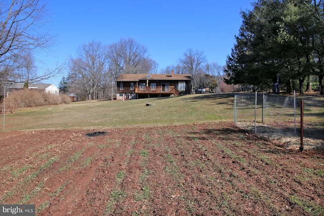 view of yard featuring a deck and fence