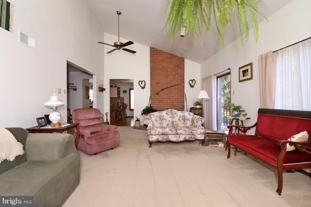 carpeted living room with visible vents, high vaulted ceiling, and a ceiling fan