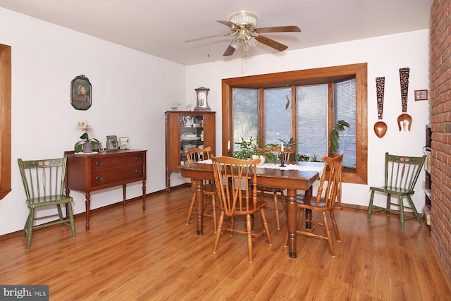 dining area featuring light wood-type flooring, baseboards, and ceiling fan