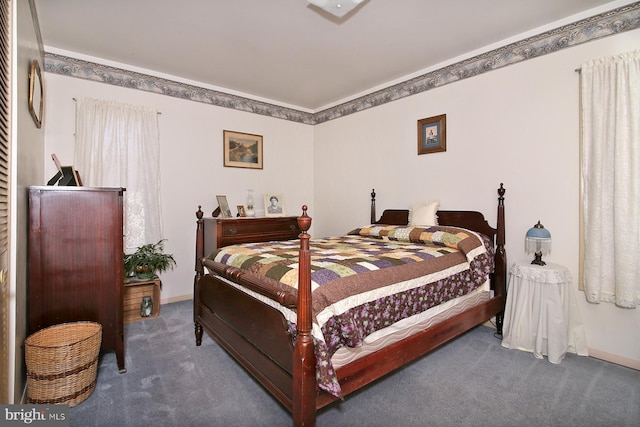 bedroom with ornamental molding, baseboards, and carpet floors