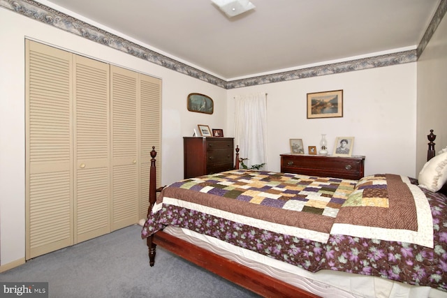 carpeted bedroom featuring crown molding and a closet