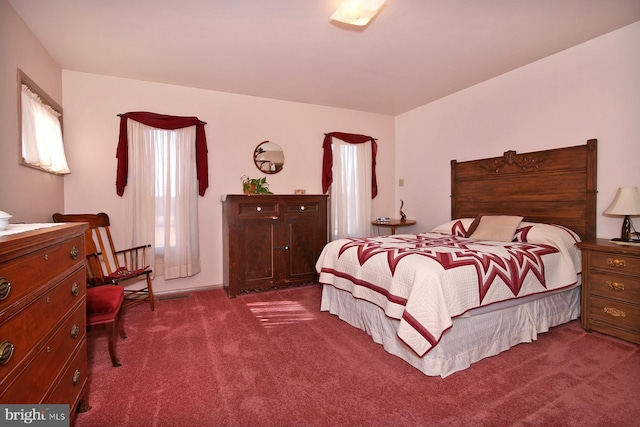 bedroom featuring dark colored carpet