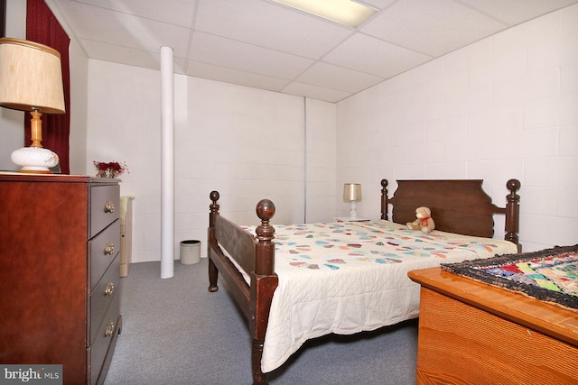 bedroom featuring a paneled ceiling and carpet floors