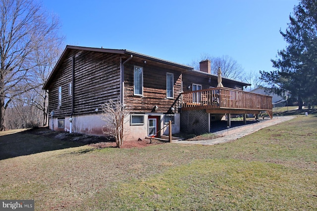 exterior space with a yard, a deck, and a chimney