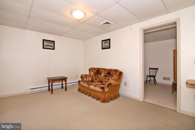 sitting room featuring visible vents, a baseboard heating unit, a paneled ceiling, and carpet floors