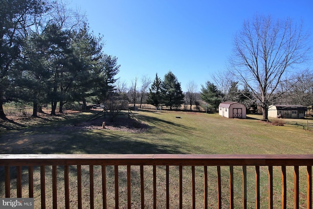 view of yard featuring an outbuilding and a storage unit