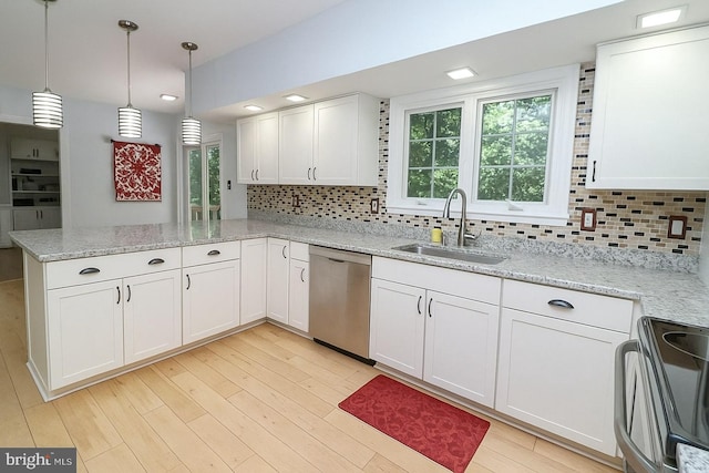 kitchen featuring electric range, a peninsula, white cabinets, a sink, and dishwasher