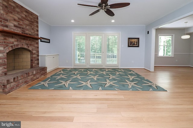 unfurnished living room with baseboards, a ceiling fan, wood finished floors, and ornamental molding