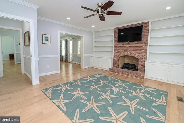 unfurnished living room featuring built in features, baseboards, a ceiling fan, and wood finished floors
