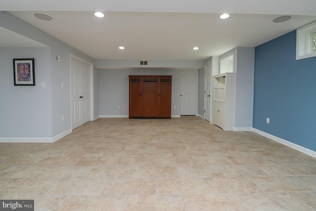interior space with baseboards, recessed lighting, and visible vents