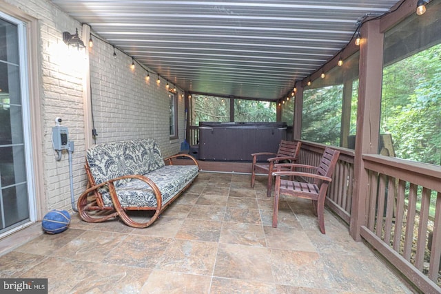 sunroom featuring a jacuzzi