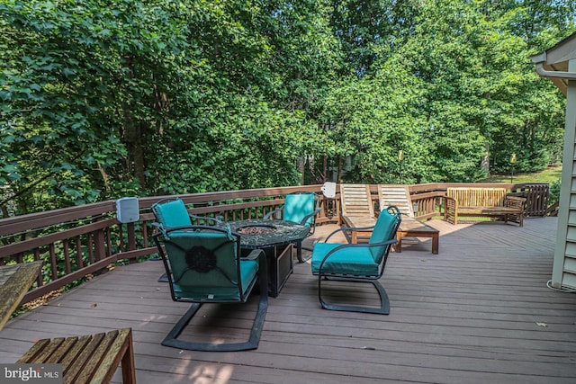 wooden terrace featuring a fire pit