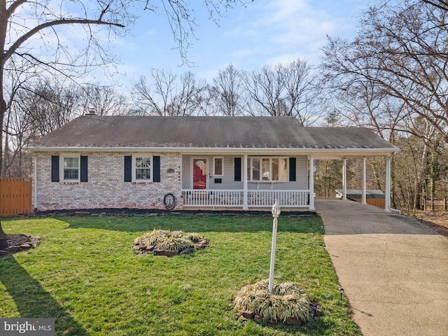 ranch-style home featuring brick siding, a porch, concrete driveway, a front yard, and a carport