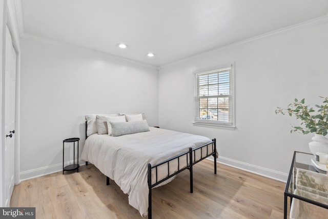 bedroom featuring recessed lighting, baseboards, crown molding, and light wood finished floors