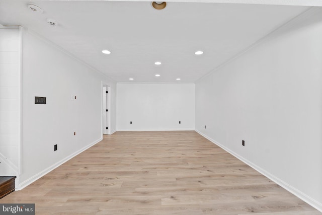 empty room featuring recessed lighting, baseboards, light wood-style floors, and ornamental molding